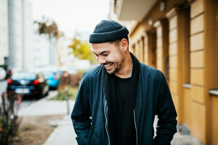 Stylish Young Man Laughing In City Street