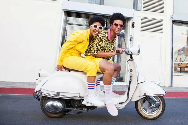 Young couple riding a scooter Young couple riding a scooter