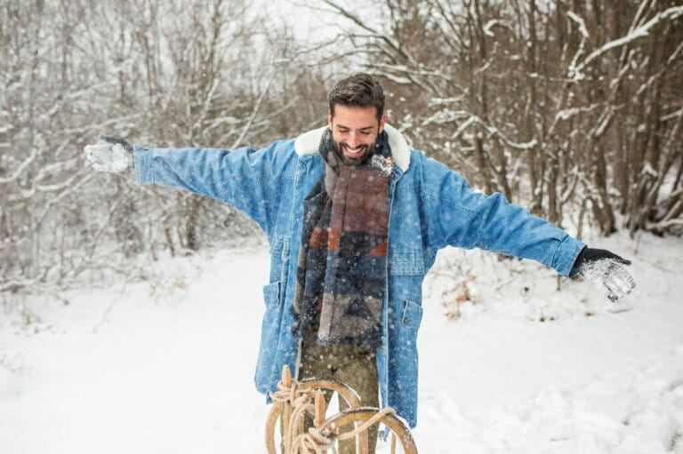Portrait of a young man enjoying the snow with a sled Portrait of a young man enjoying the snow with a sled