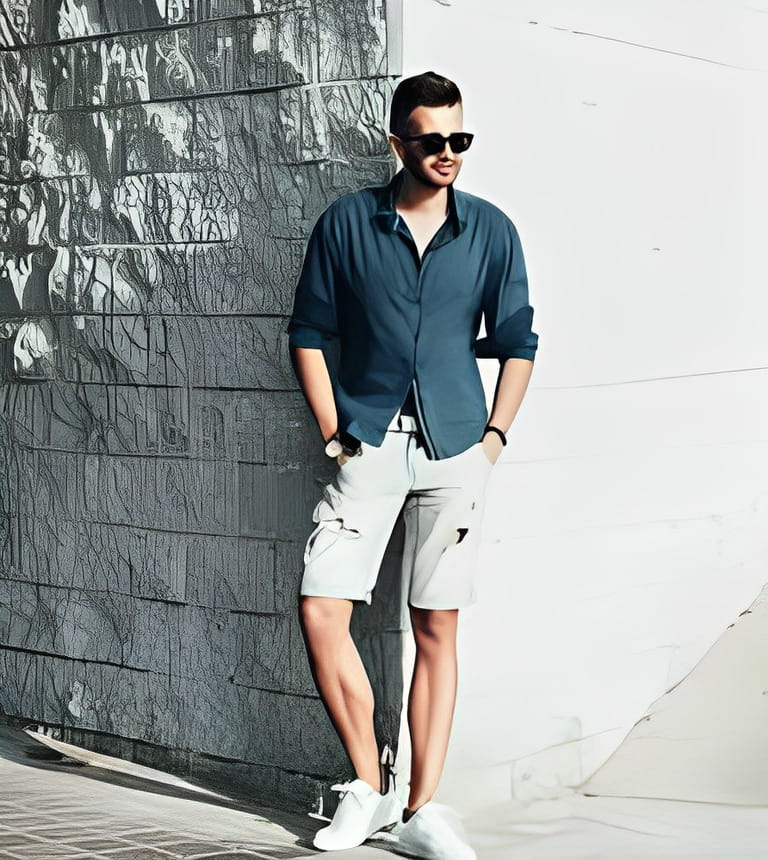 Stylish fashion man posing in shorts and shirt Stylish fashion man posing in shorts and shirt