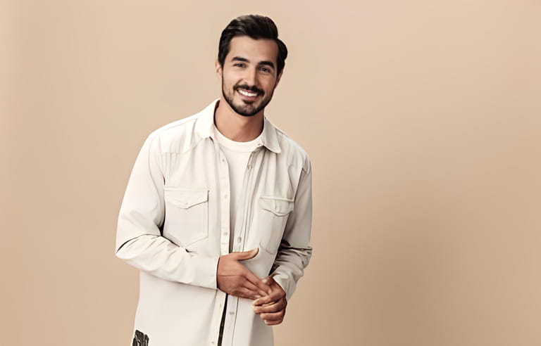 Stylish man smile on a beige background in a white t-shirt and business jacket, flying clothes hero, fashionable clothing style