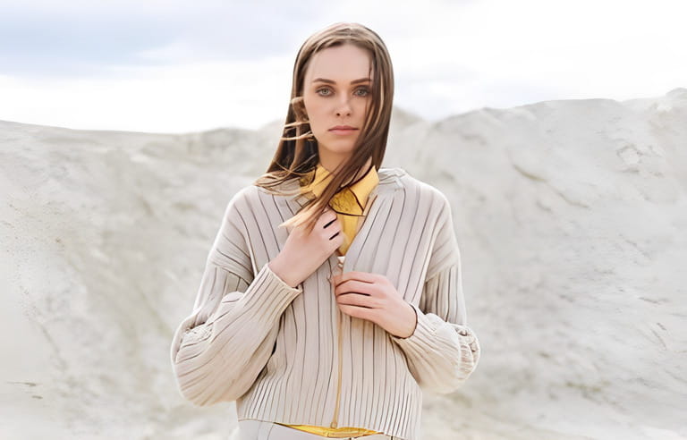 Fashion beauty portrait of young woman with long hair in knitted cardigan on desert background, autumn outfit Fashion beauty portrait of young woman with long hair in knitted cardigan on desert background, autumn outfit