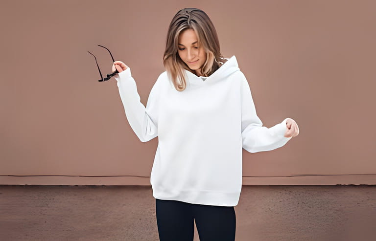 White hoodie on a young woman, mockup. Lifestyle.