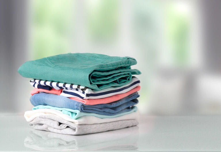 Stack colorful cotton clothes on a background table
