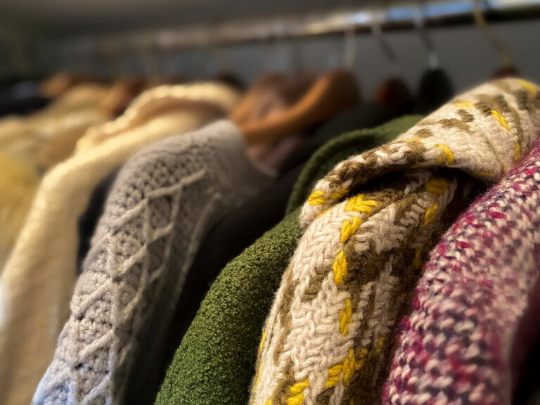 Collection of vintage coats hanging in walk-in closet