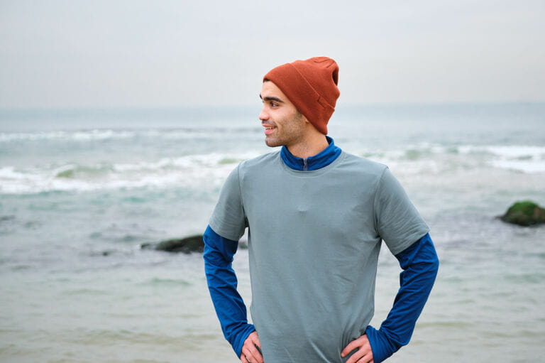 Young men 20-24 years old exercise at the beach in cold temperatures Young men 20-24 years old exercise at the beach in cold temperatures