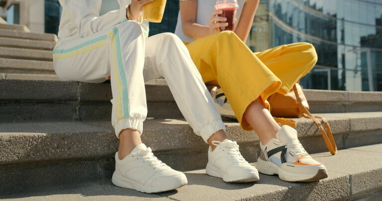 Friends, feet and shoes on city stairs for bonding, travel and urban rest with drinks, smoothies and drinks, Couples, people and town stairs for fashion Friends, feet and shoes on city stairs for bonding, travel and urban rest with drinks, smoothies and drinks, Couples, people and town stairs for fashion
