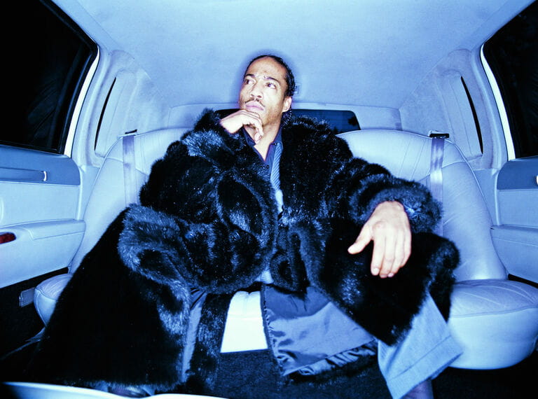 Man in back of car, interior view