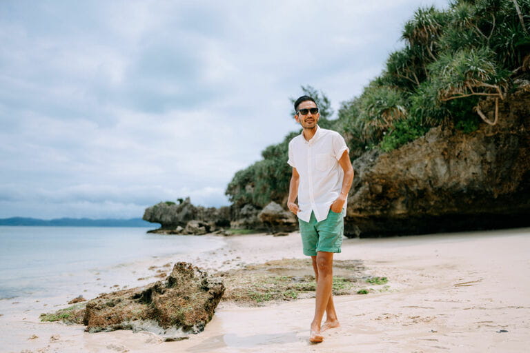 Man walking on tropical beach, Japan Man walking on tropical beach, Japan