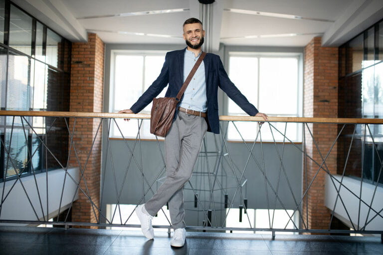 Office workers stand and wait for colleagues near the stairs Office workers stand and wait for colleagues near the stairs