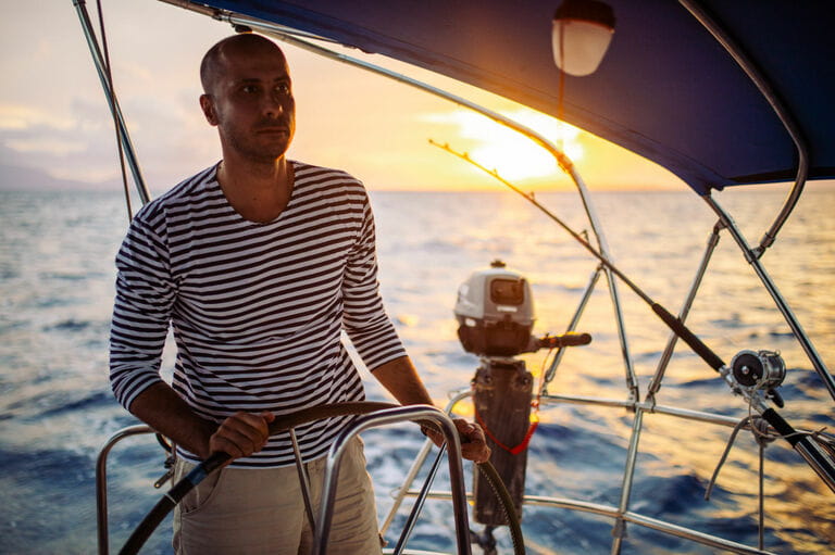Man sailing at sunset