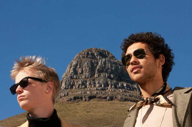 Portrait of two handsome young men with clear blue sky as background Portrait of two handsome young men with clear blue sky as background
