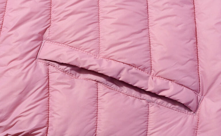 A piece of pink fabric with down filling and stitching, fabric for coats and jackets A piece of pink fabric with down filling and stitching, fabric for coats and jackets