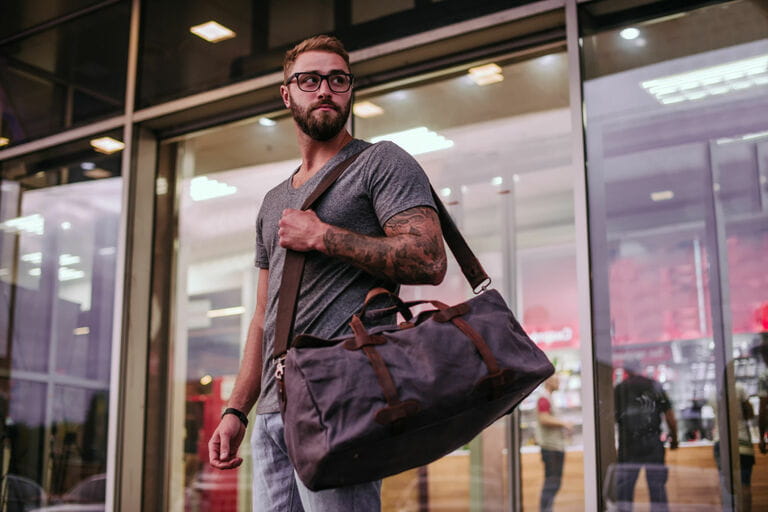 Millennials man in casual clothes and eyeglasses with a canvas bag